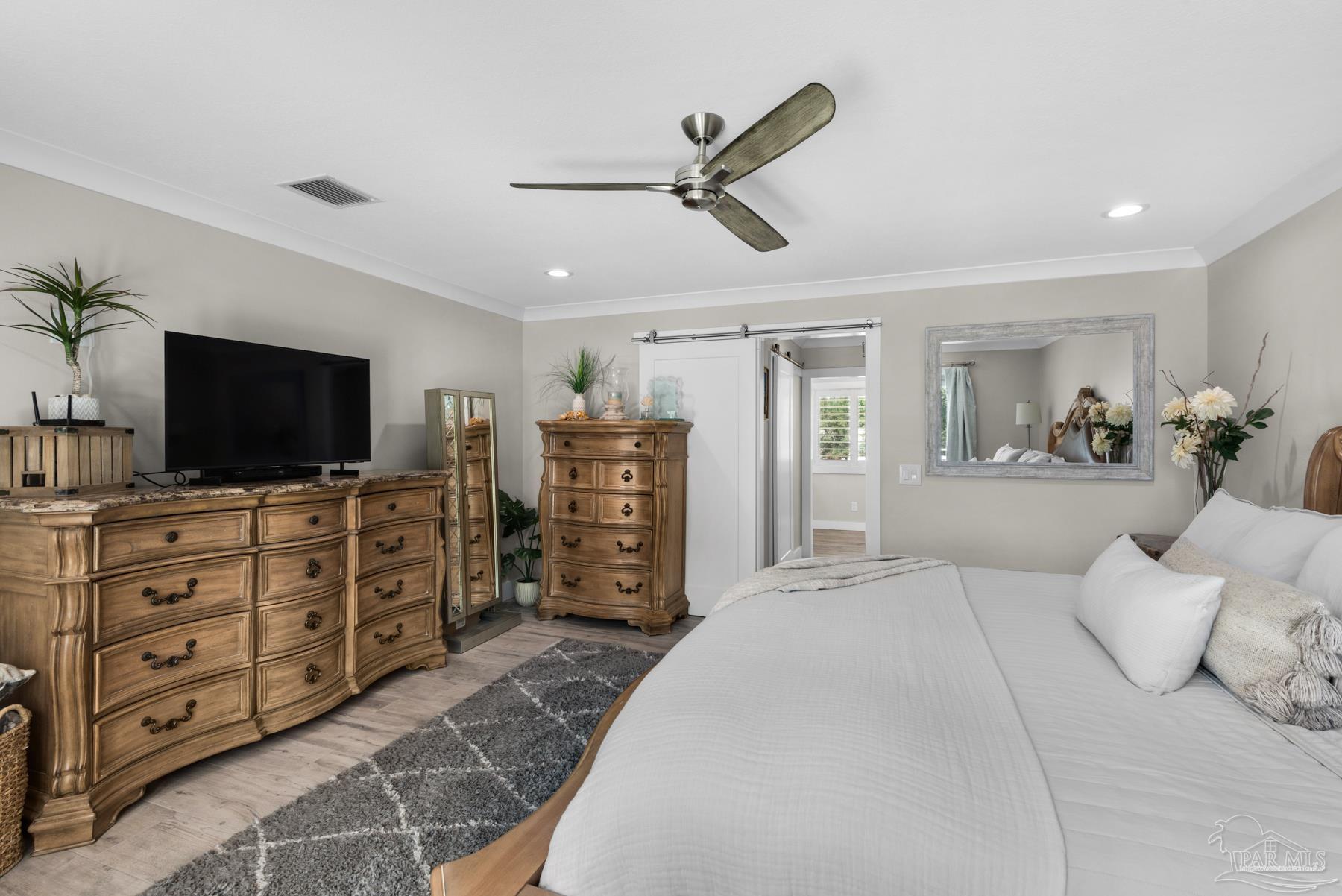 2829 Bay Street Gulf Breeze, FL 32563 - Photo 22 of 69 a large bedroom with a bed and flat screen tv