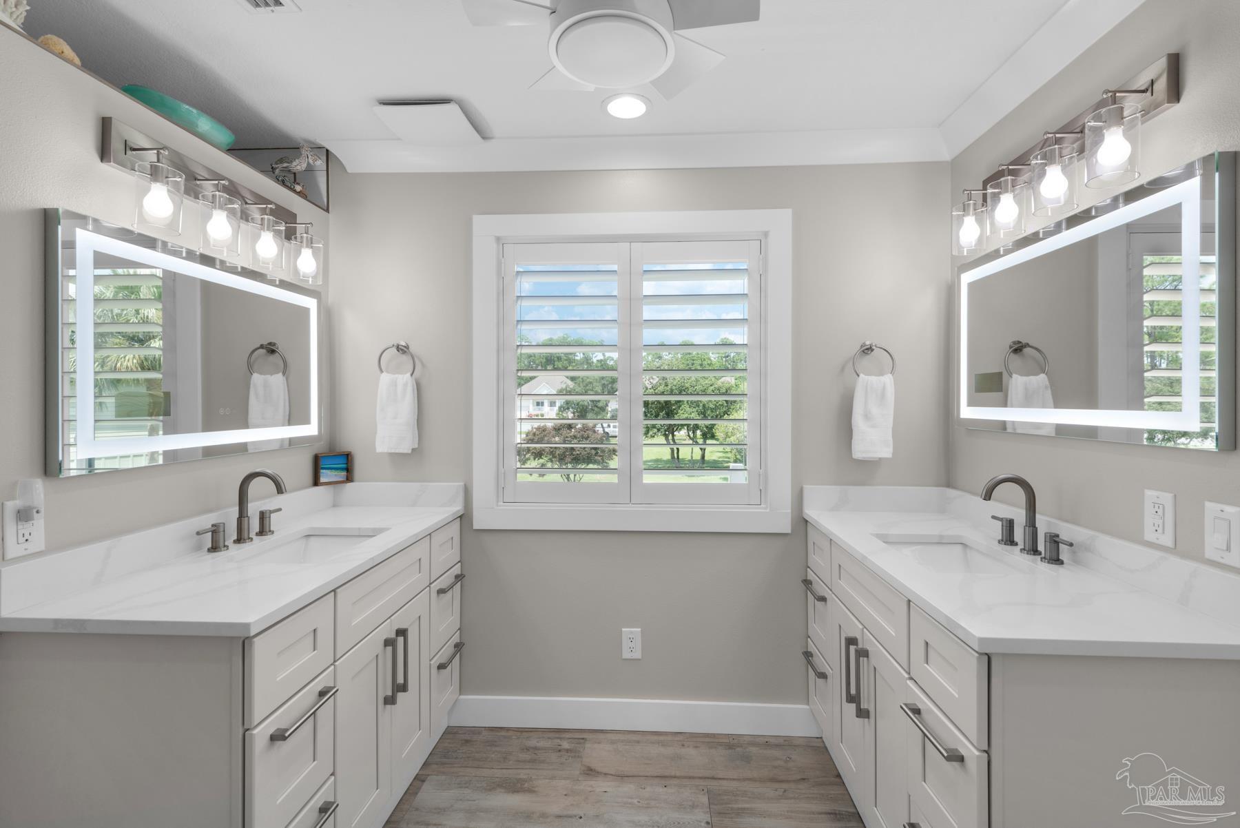 2829 Bay Street Gulf Breeze, FL 32563 - Photo 23 of 69 a bathroom with double vanity sink a mirror a and a window