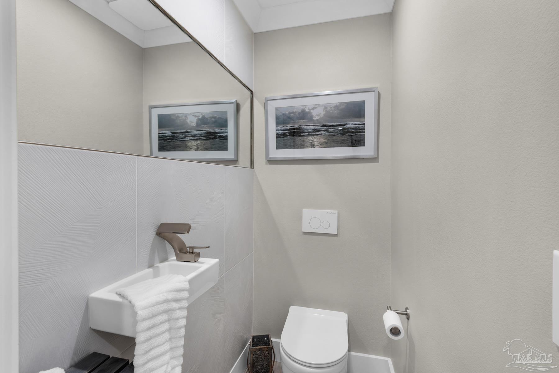 2829 Bay Street Gulf Breeze, FL 32563 - Photo 31 of 69 a white toilet sitting next to a bathroom sink