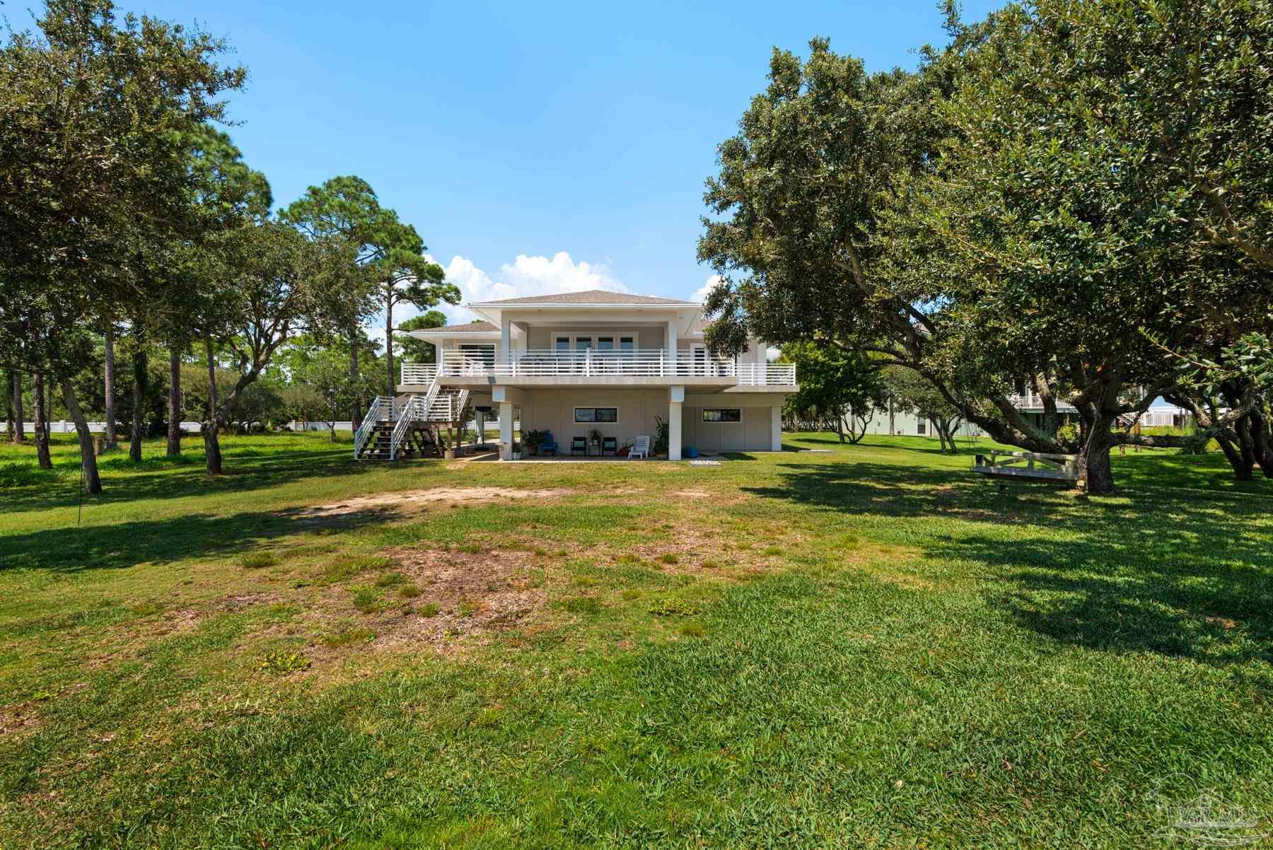 2829 Bay Street Gulf Breeze, FL 32563 - Photo 34 of 69 a view of house with outdoor space and garden