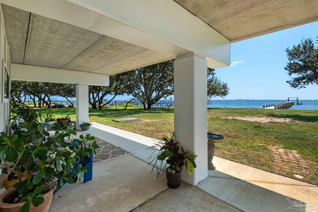 a view of a patio with dining table and chairs