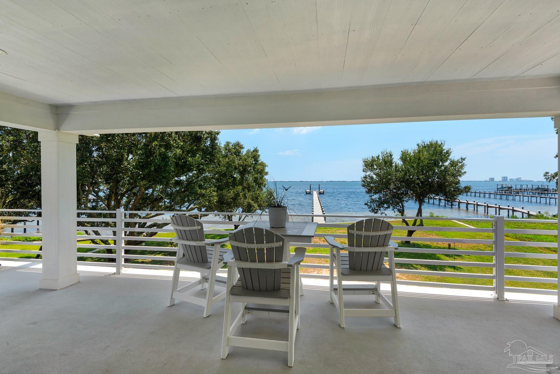 2829 Bay Street Gulf Breeze, FL 32563 - Photo 46 of 69 a view of a swimming pool with an outdoor seating and a garden