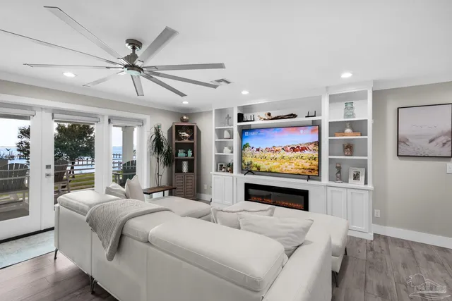 a kitchen with granite countertop stainless steel appliances and wooden floor