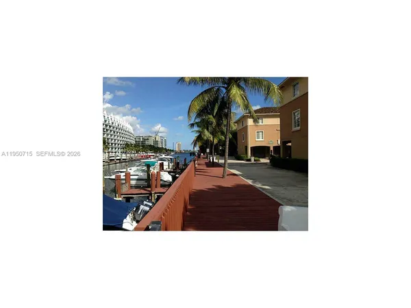 a picture of a living room with a couch and chandelier