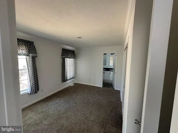 an empty room with windows and entrance