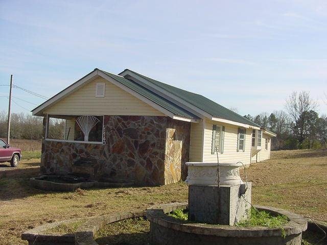 1140 Fairview Road Northwest Calhoun, GA 30701 - Photo 1 of 1 a front view of a house with a yard