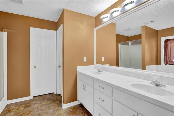 a bathroom with a double vanity sink and a mirror