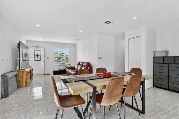 a dining room with furniture and wooden floor