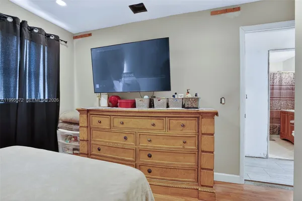a bedroom with a bed and a flat screen tv
