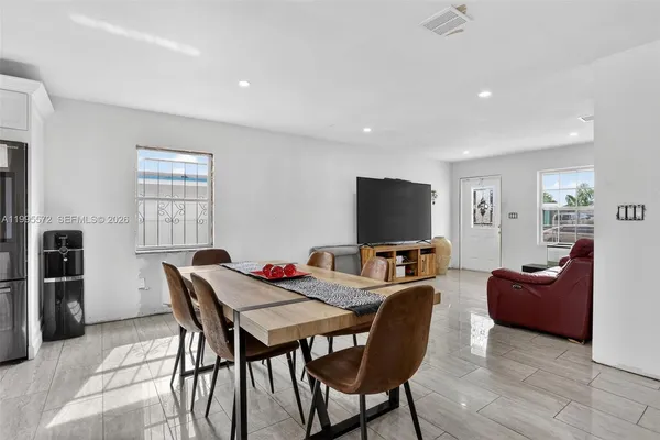 a view of a livingroom with furniture and a flat screen tv
