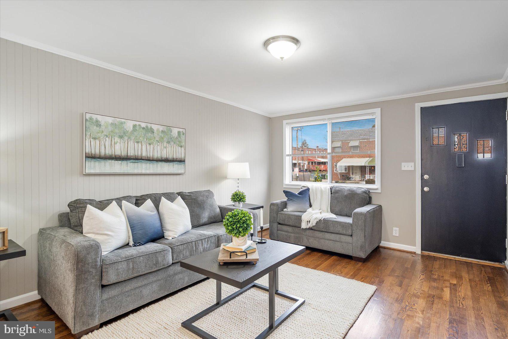 Spacious living room featuring restored hardwoods