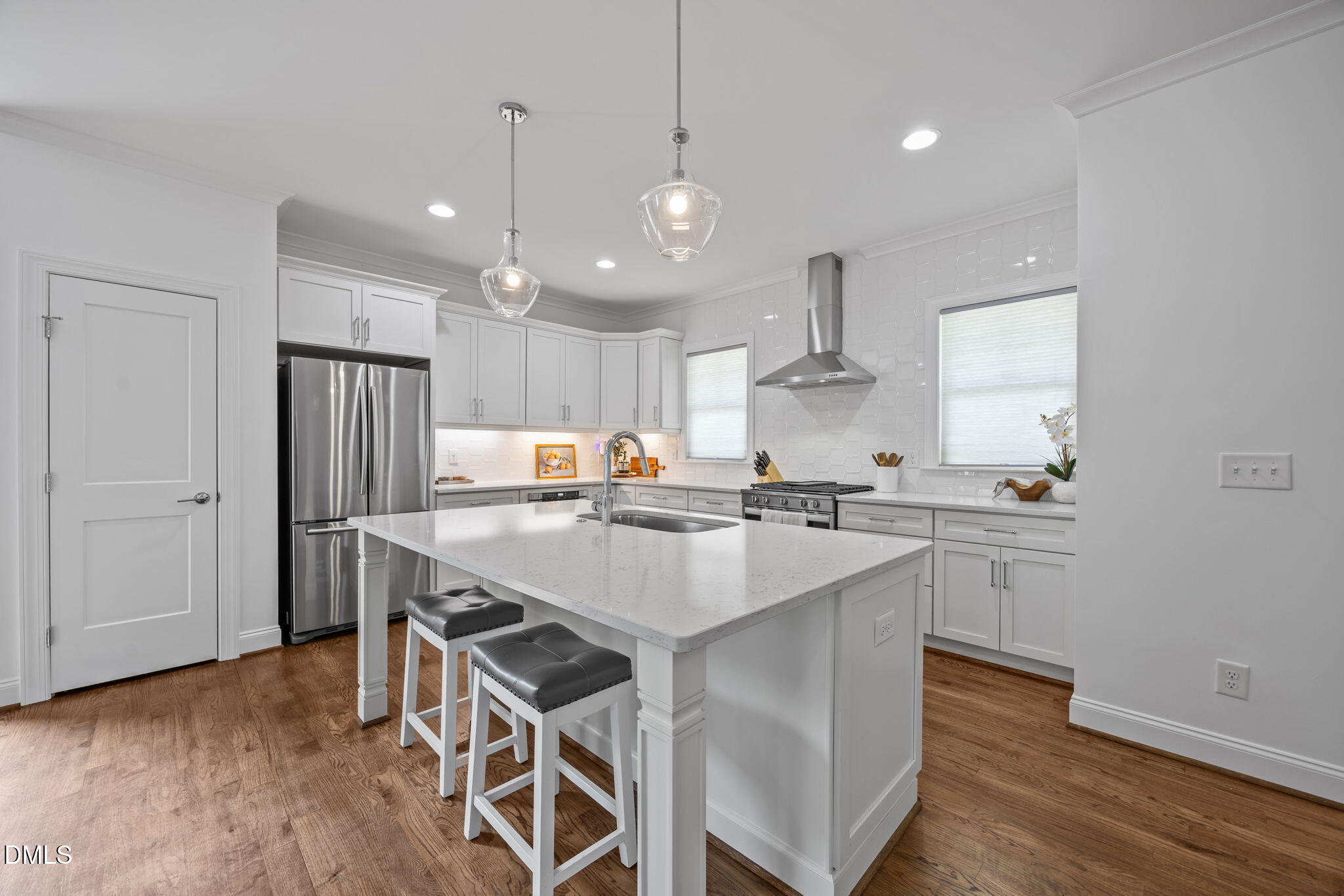 804 Hartford Road Raleigh, NC 27610 - Photo 2 of 26 a kitchen with kitchen island a sink stainless steel appliances and wooden floor