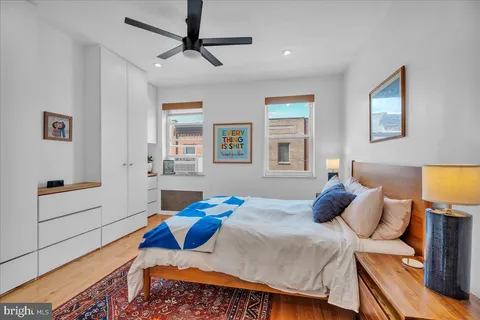a bedroom with a bed and a painting on the wall