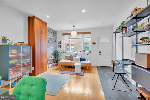 a living room with furniture fireplace and a large window
