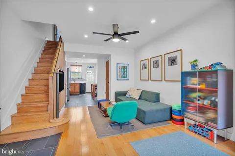 a living room with furniture and a dining table