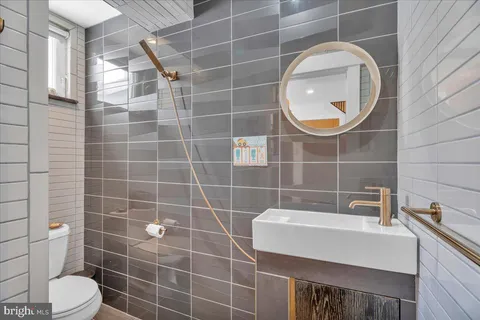 a bathroom with a sink mirror toilet and shower