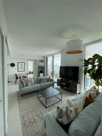 a living room with furniture and a rug