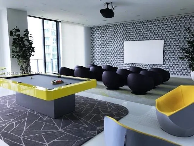 a view of a livingroom with furniture and floor to ceiling window