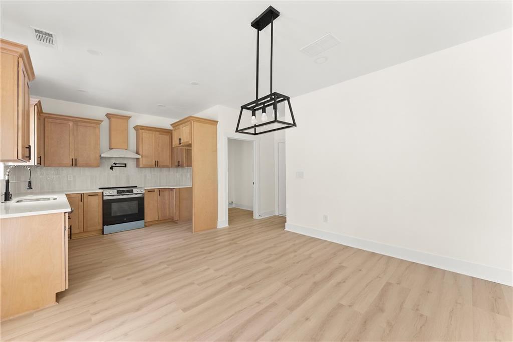 172 Llewellyn Street Clarkesville, GA 30523 - Photo 13 of 49 a kitchen with kitchen island a counter top space a sink and cabinets
