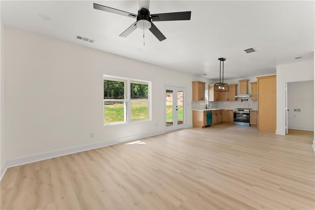 172 Llewellyn Street Clarkesville, GA 30523 - Photo 15 of 44 a view of a livingroom with a ceiling fan window and wooden floor