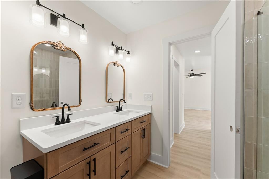 172 Llewellyn Street Clarkesville, GA 30523 - Photo 23 of 44 a bathroom with a double vanity sink and a mirror