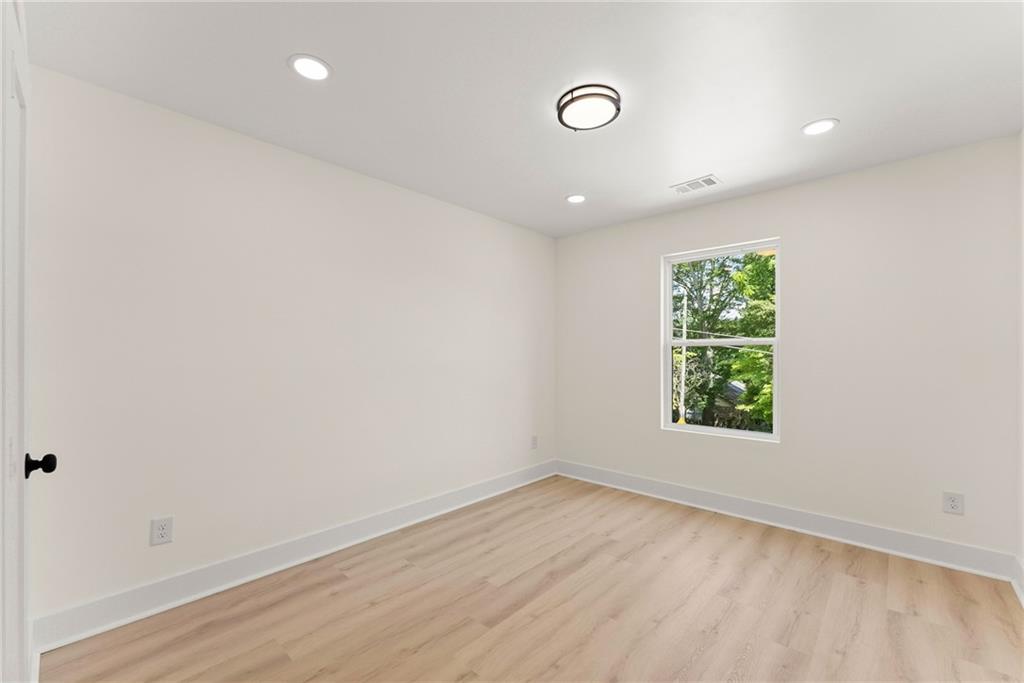 172 Llewellyn Street Clarkesville, GA 30523 - Photo 25 of 44 an empty room with wooden floor and windows