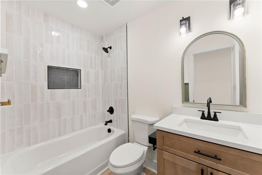172 Llewellyn Street Clarkesville, GA 30523 - Photo 27 of 44 a bathroom with a sink a toilet a mirror and shower