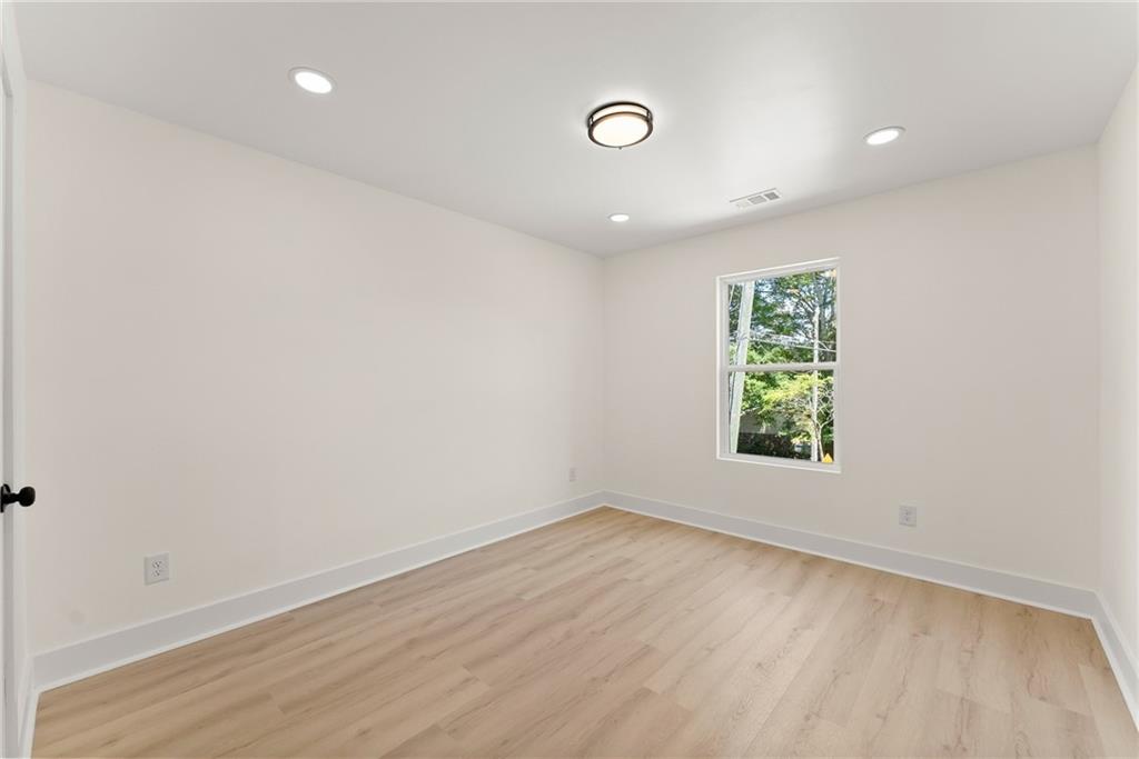 172 Llewellyn Street Clarkesville, GA 30523 - Photo 30 of 44 an empty room with wooden floor and window
