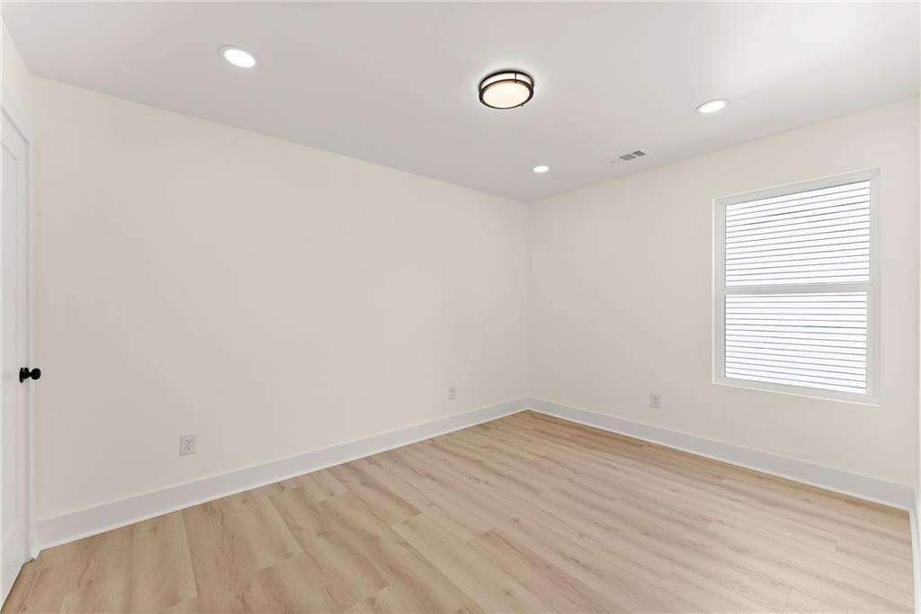 172 Llewellyn Street Clarkesville, GA 30523 - Photo 33 of 49 an empty room with wooden floor and windows