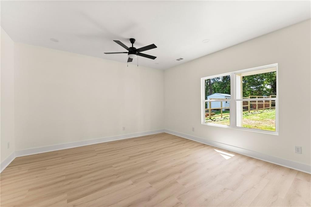 172 Llewellyn Street Clarkesville, GA 30523 - Photo 4 of 44 wooden floor in an empty room with a window