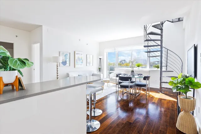 a white kitchen with a sink and a window