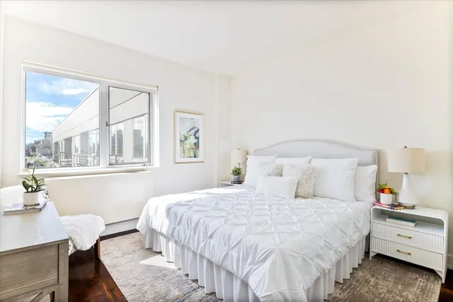 a living room with patio furniture and a potted plant