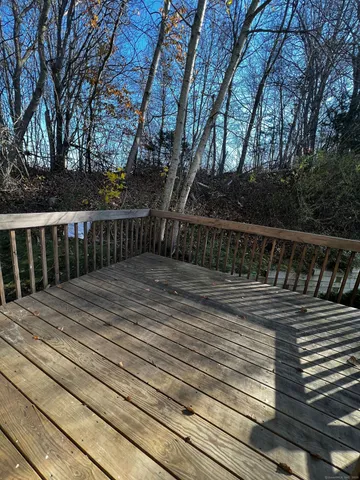a view of deck with wooden floor and fence
