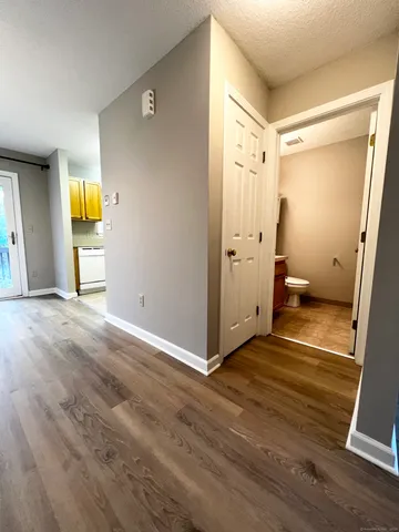 a view of a room with wooden floor and bathroom