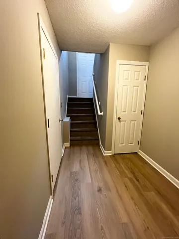a view of an entryway with wooden floor