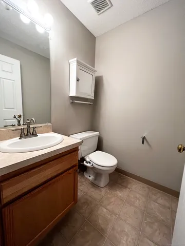 a bathroom with a sink a toilet and mirror