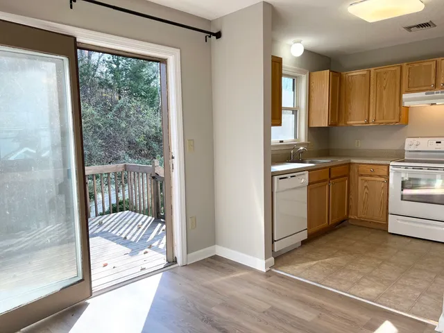 a kitchen with a window a sink and a refrigerator