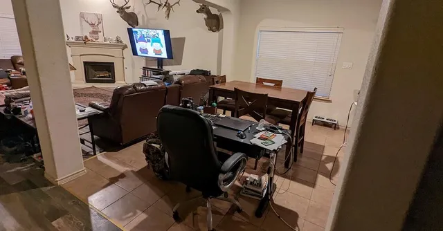 a living room with furniture a fireplace and a flat screen tv