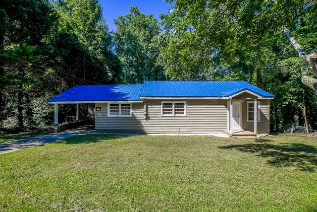 a front view of a house with a yard