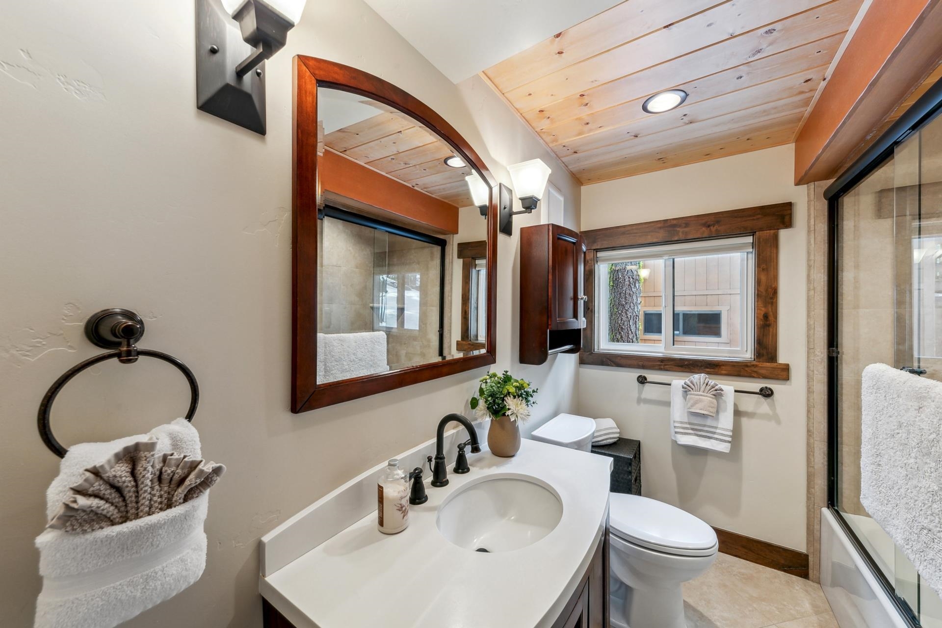 15501 Conifer Drive Truckee, CA 96161 - Photo 12 of 28 a bathroom with a toilet sink and mirror