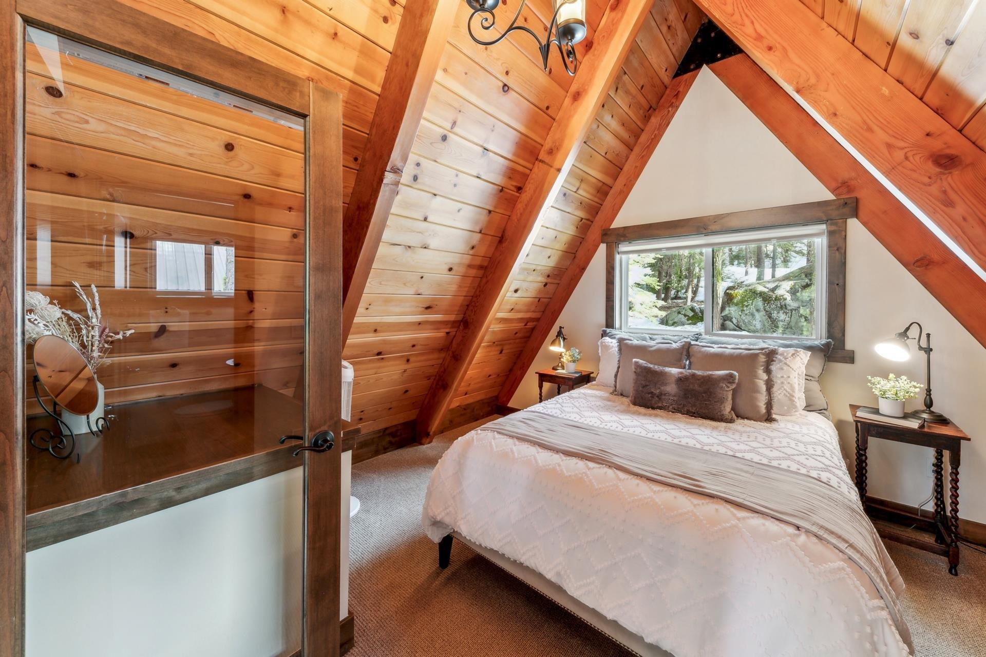 15501 Conifer Drive Truckee, CA 96161 - Photo 15 of 28 a bedroom with a bed a large window with the outer view