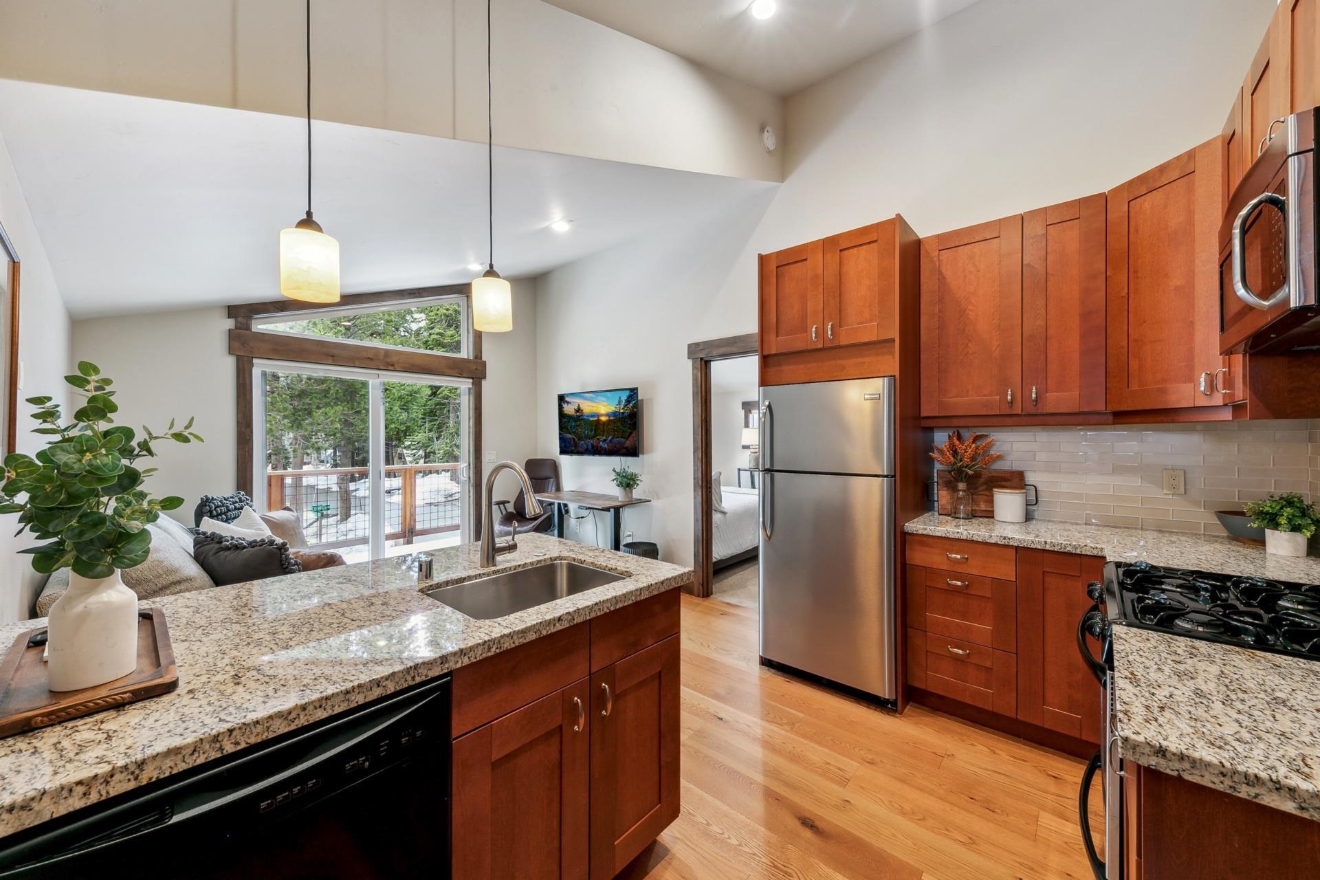 15501 Conifer Drive Truckee, CA 96161 - Photo 20 of 28 a kitchen with granite countertop a sink a counter space appliances and cabinets