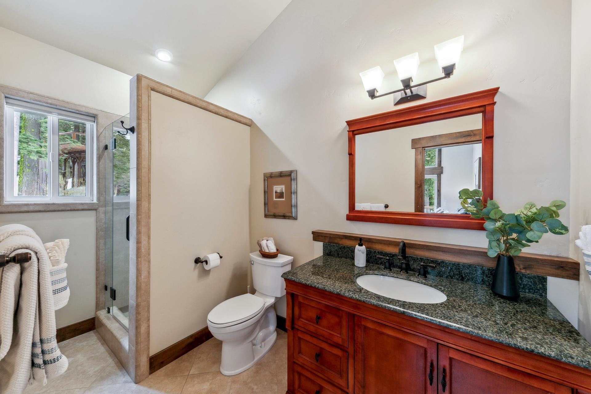 15501 Conifer Drive Truckee, CA 96161 - Photo 24 of 28 a bathroom with a granite countertop sink mirror vanity and toilet