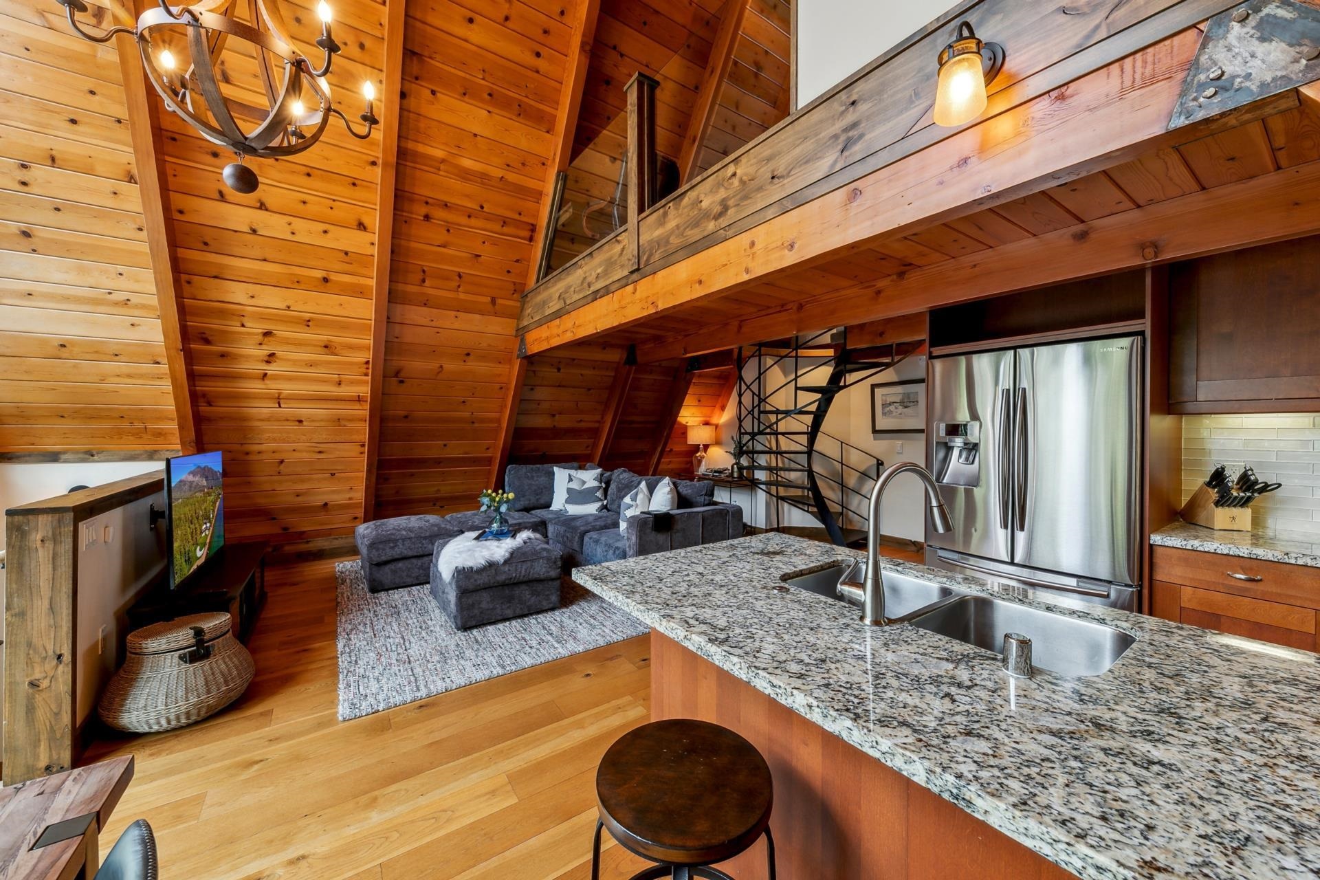 15501 Conifer Drive Truckee, CA 96161 - Photo 7 of 28 a kitchen with granite countertop sink and cabinets