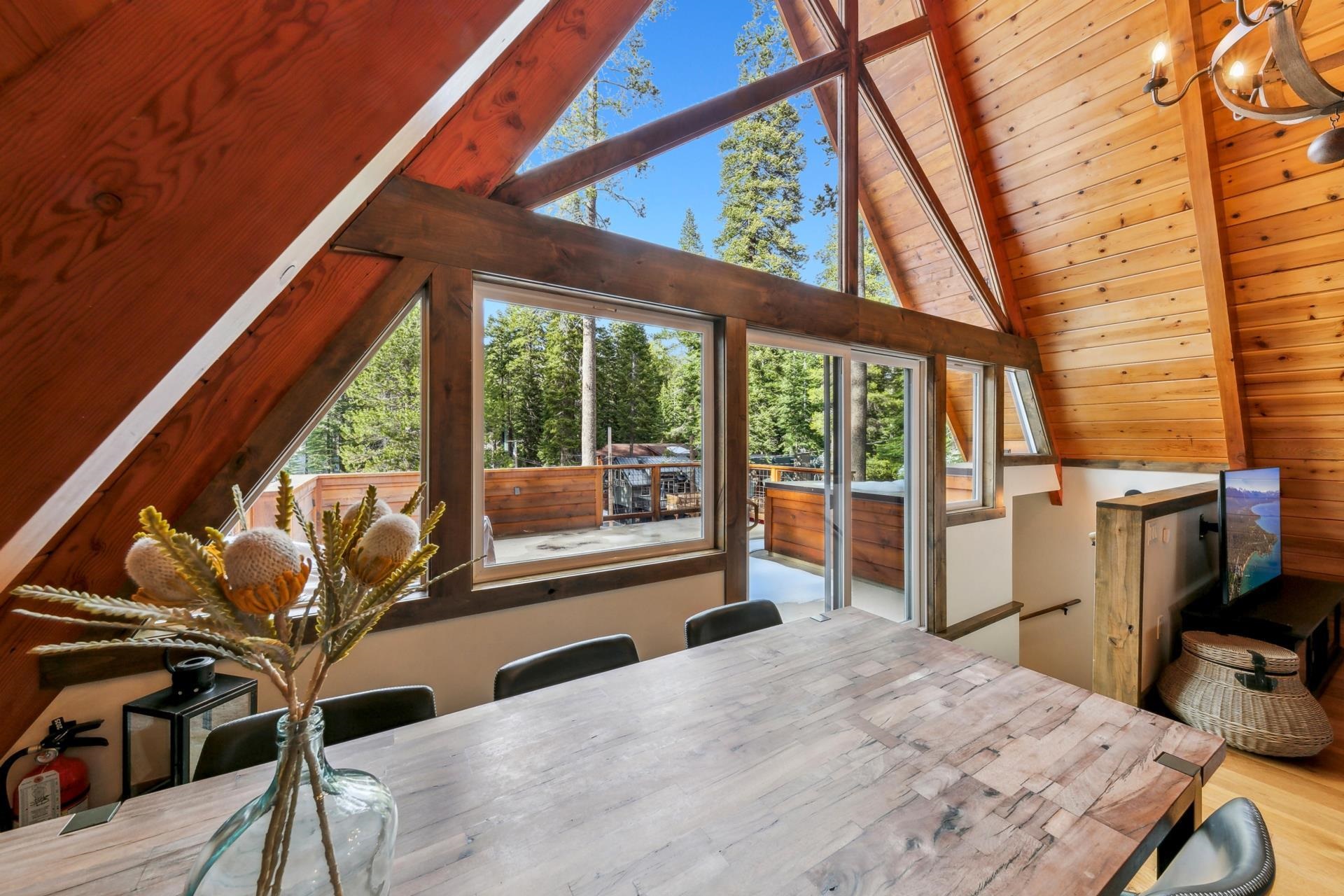 15501 Conifer Drive Truckee, CA 96161 - Photo 9 of 28 a bedroom with a bed and large windows