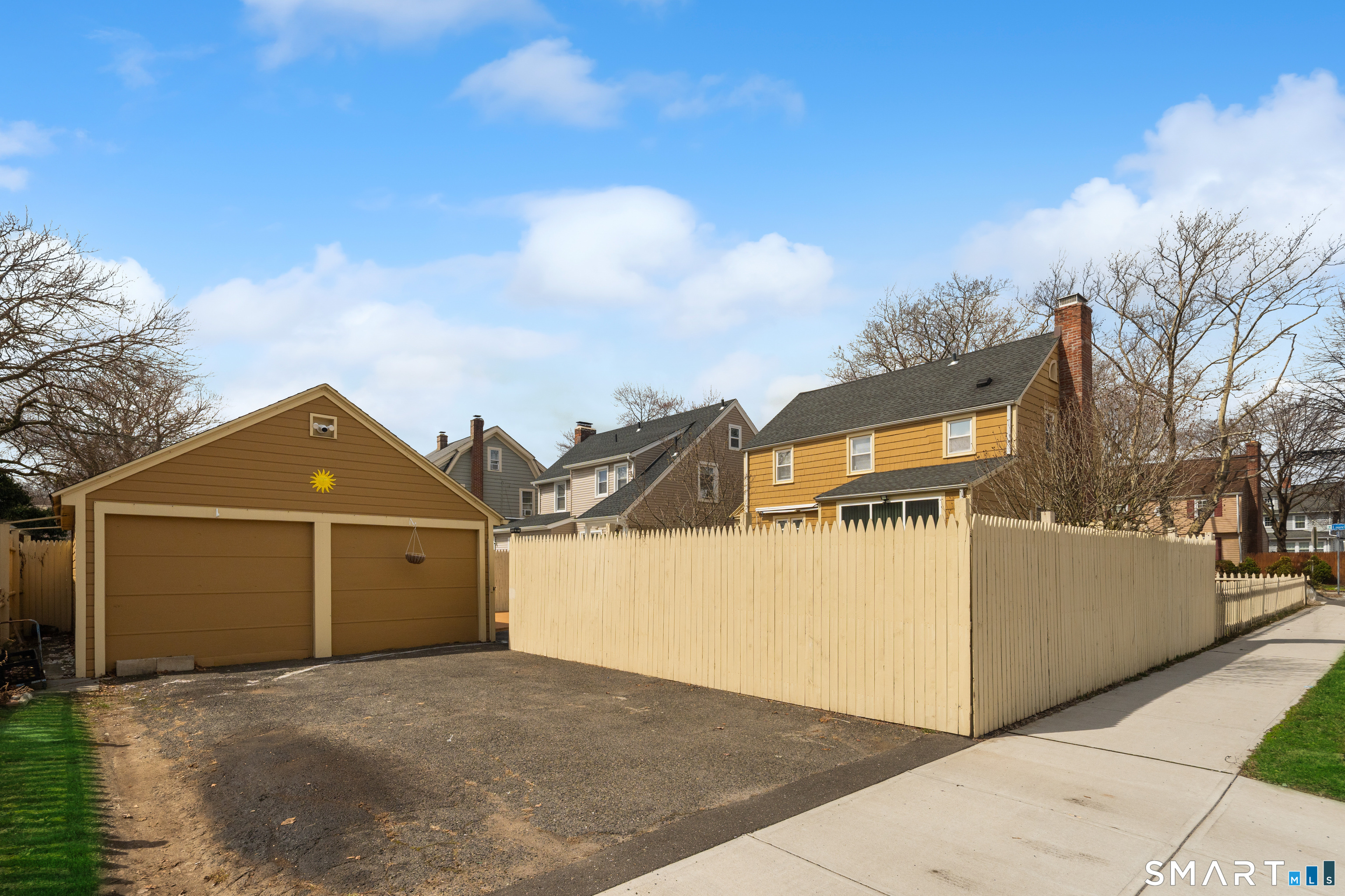 135 Laurel Place Bridgeport, CT 06604 - Photo 12 of 35 a view of a big house with wooden fence