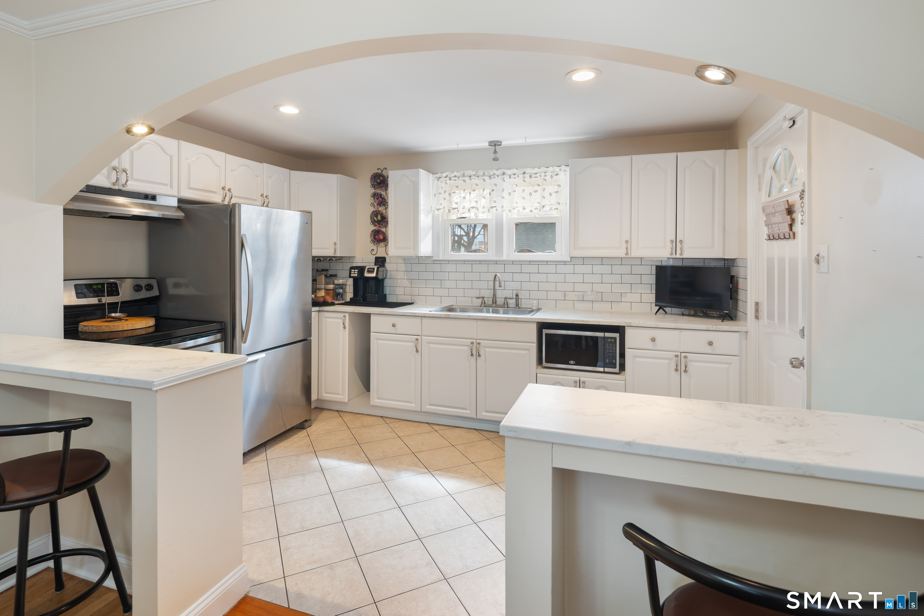 135 Laurel Place Bridgeport, CT 06604 - Photo 24 of 35 a kitchen with stainless steel appliances a stove a sink a microwave a refrigerator a stove and white cabinets