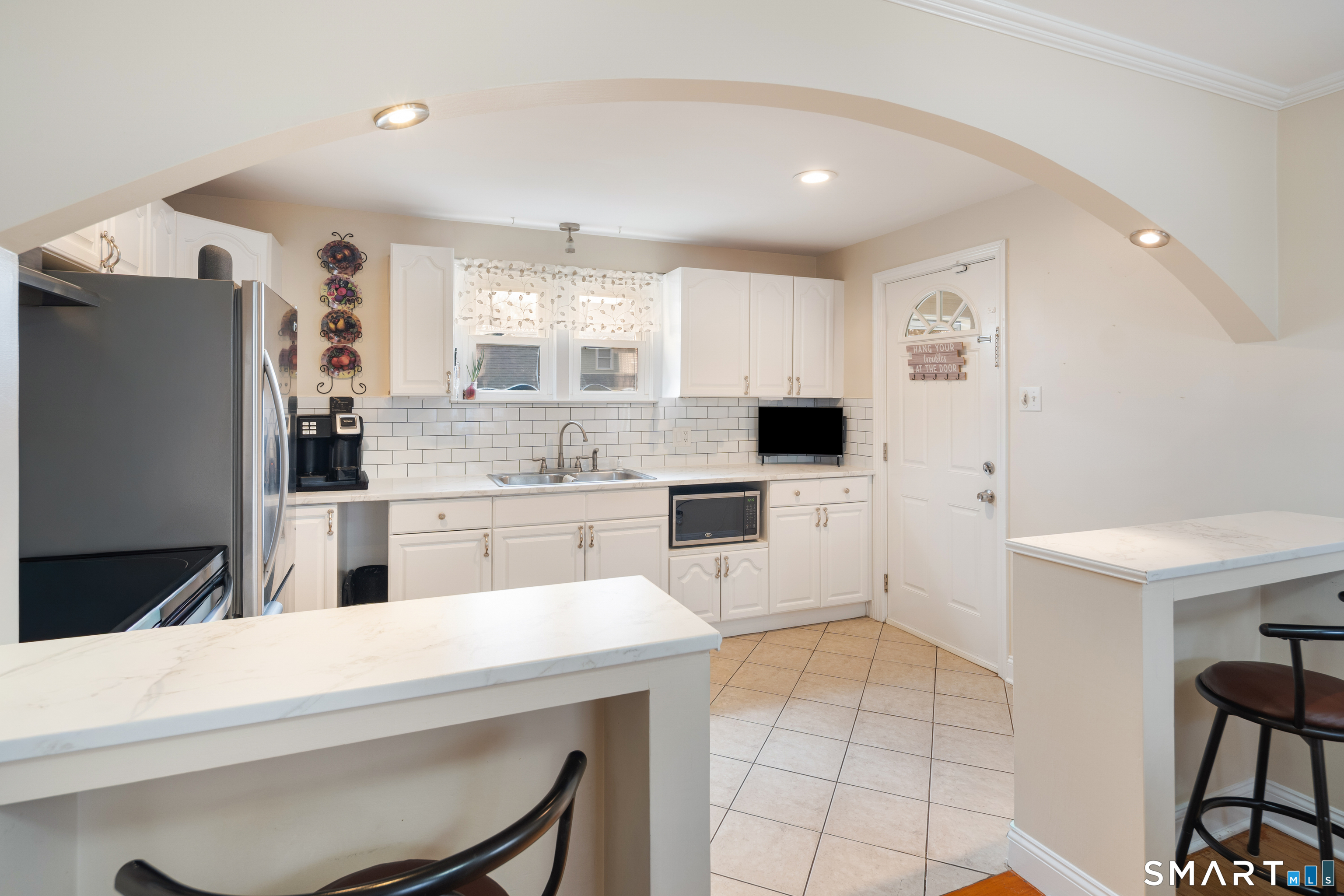 135 Laurel Place Bridgeport, CT 06604 - Photo 25 of 35 a kitchen with cabinets and chairs