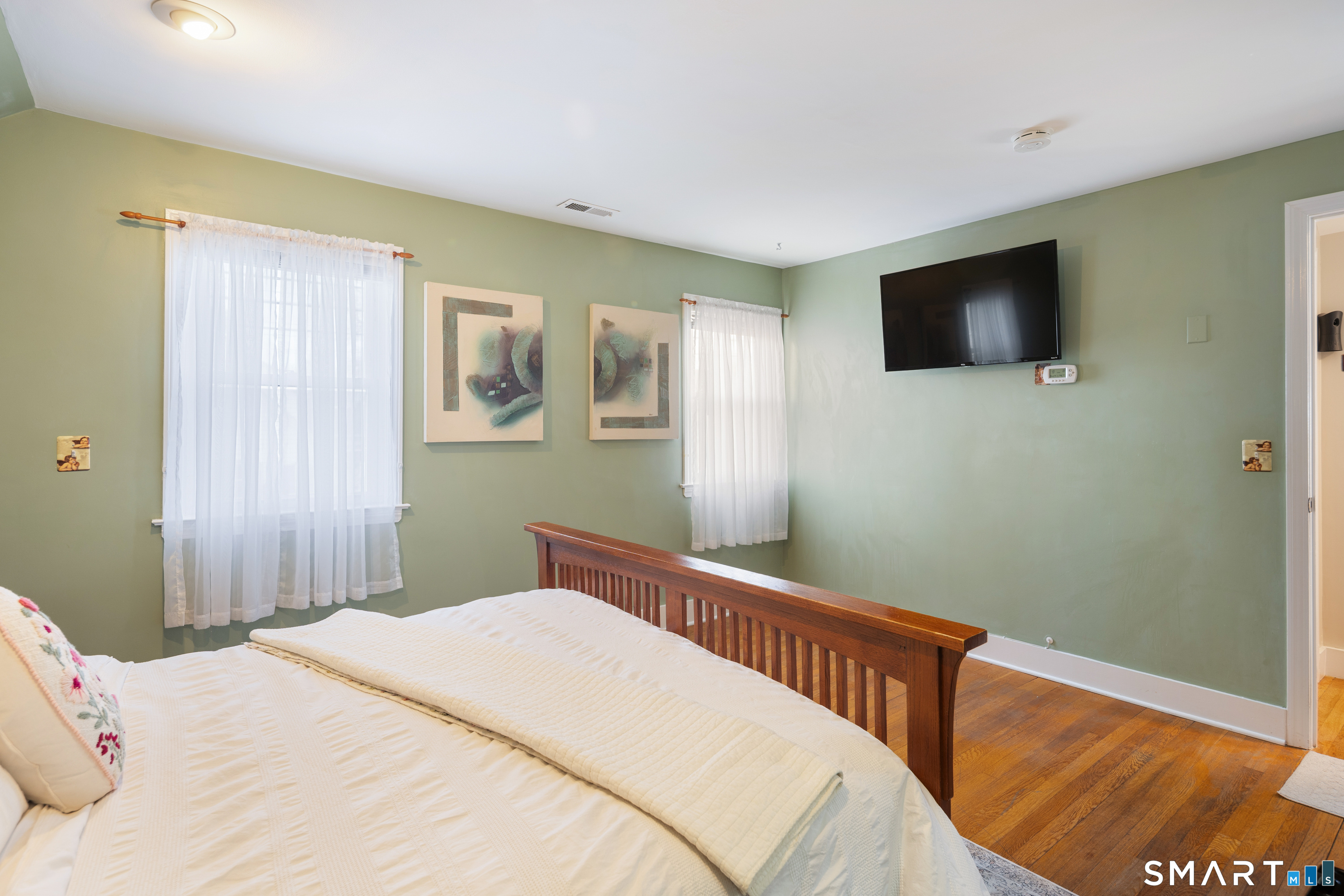 135 Laurel Place Bridgeport, CT 06604 - Photo 28 of 35 a bedroom with a bed and a flat screen tv