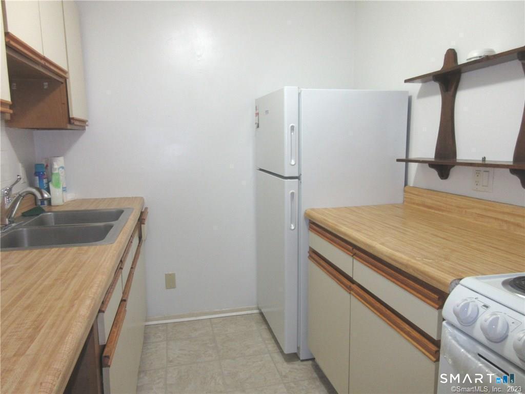 5 Nabby Road, Unit A17 Danbury, CT 06811 - Photo 5 of 11 a kitchen with a sink and a refrigerator